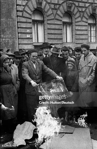 Hungarians burn a picture of the Communist Soviet leader Josef Stalin during the anti-Communist revolution in 1956.