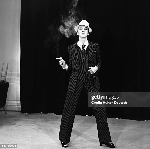 Model wears a three-piece suit designed by Yves Saint Laurent. France, 1967.