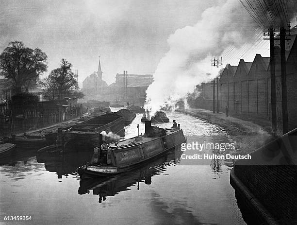 Grand Union Canal at Kensal Green Gas Works. Photo shows: A view of the Grand Union canal at Kensal Green. Showing various barges.
