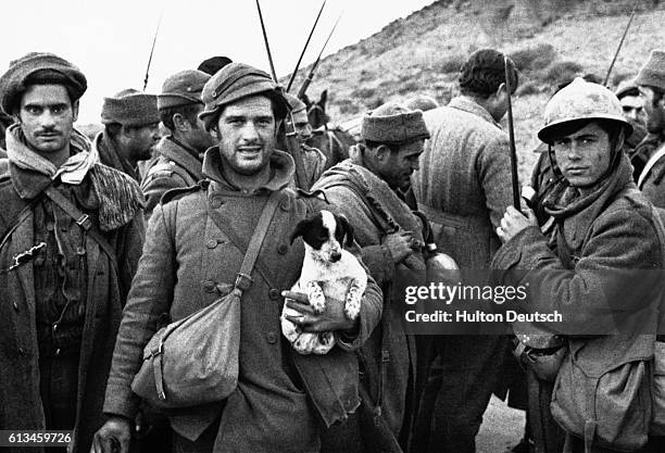 Group of Republican soldiers talk to journalists during the Spanish Civil War, including the American novelist Ernest Hemingway , who served as a war...