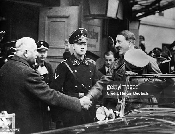 Adolf Hitler shakes hands before he makes his renunciation of the Locarno Pact.