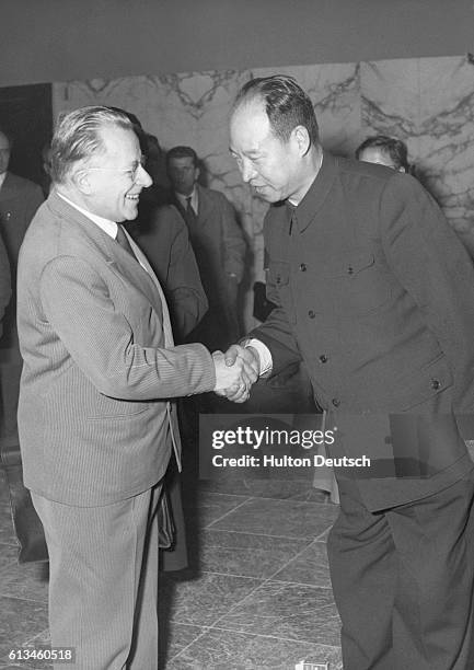 The leader of the Italian communist party Palmiro Togliatti shakes hand with China's Peng Chen at the party's eighth congress in Rome.