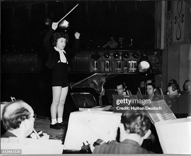 Eight year old boy Ferugio Burgo conducts the Concerts Colones Orchestra at the Chatelet Theater in Paris during a rehearsal.