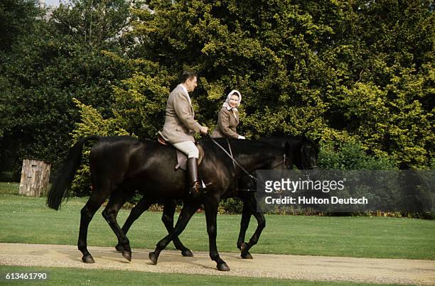 President Reagan and Nancy Reagan goes horse riding with Queen Elizabeth II of Great Britain. Queen Elizabeth II, born in London in 1926, Queen of...