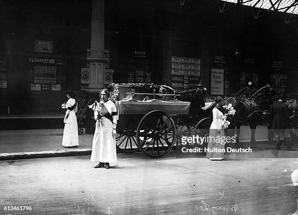 Suffragettes Mary Leigh and Mrs Yates stand guarding the coffin of their fellow campaigner Emily Davison, who was killed making a protest at the 1913...