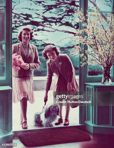 Princesses Elizabeth and Margaret with their dog Chung at the Royal Lodge at Windsor.