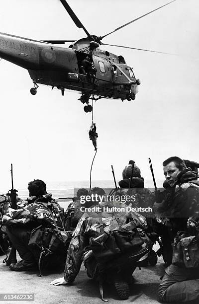 Royal Marines from 40 Commando troop await transport from the deck of the HMS Hermes onto the Sea King helicopters enroute to the Falklands Islands.