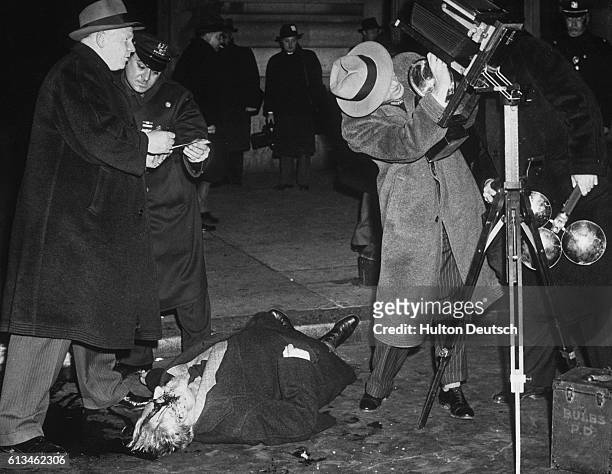 Journalists prepare to photograph the body of Carlo Tresca, leader of New York's Italian anti-fascist group and editor of the anti-fascist newspaper...