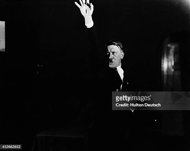Hitler practices his speech making in front of a photographer so he can study their dramatic impact.