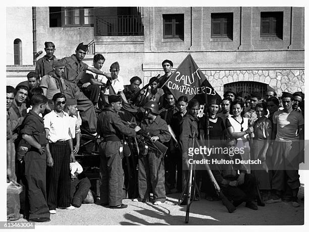 Rifles are distributed to anarchist and syndicalist soldiers at Barcelona during the Spanish Civil War. | Location: Barcelona, Spain.