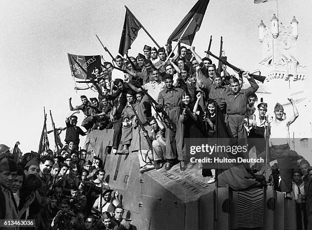 Anarchist militia from the National Confederation of Labour wave their flags and rifles for the camera in Barcelona during the Spanish Civil War. |...