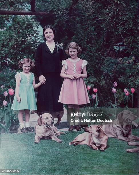 The Duchess of York with her daughters Princess Elizabeth and Princess Margaret in the garden of the Royal Lodge at Windsor.