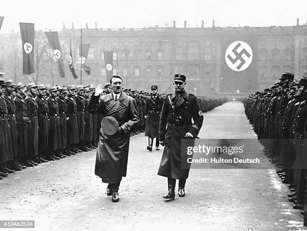 The German Chancellor Adolf Hitler with Herr Lutze, his chief of staff, during a review of the storm troopers in Berlin to mark the third anniversary...