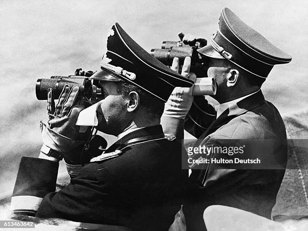 Hitler and Nazi Foreign Minister Joachim von Ribbentrop look through binoculars.