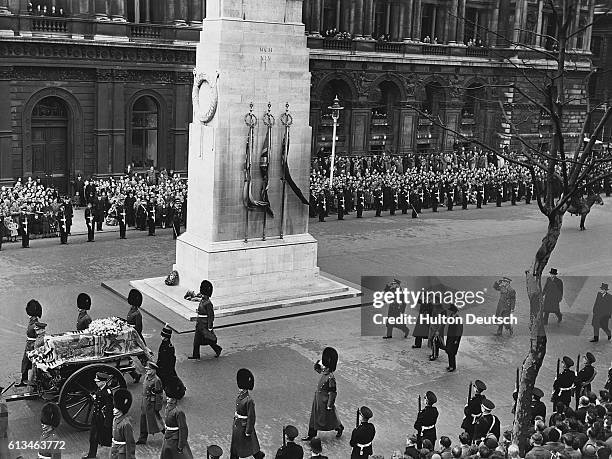The funeral procession of the late Queen Mary, wife of the late King George V of England, passes the Cenotaph on its way from Marlborough House to...