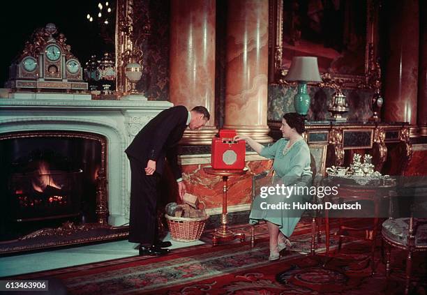 King George VI and Queen Elizabeth of England at home in Buckingham Palace.