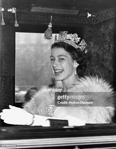 Queen Elizabeth II of England drives to Westminster to open Parliament in State in the first year of her reign.