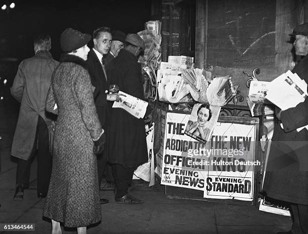 People surround a newspaper stand in Parliament Square, London, to read the news of King Edward VIII's abdication.