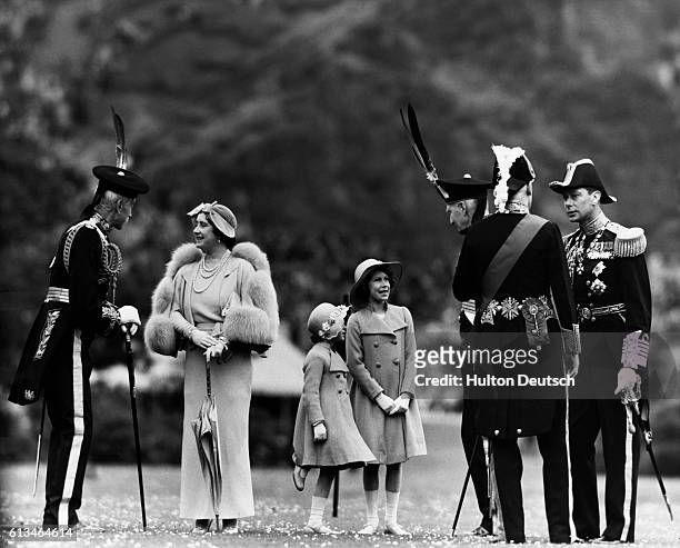 Queen Elizabeth chats to Lord Elphinstone during a royal inspection of the Royal Company of Archers at Holyrood Palace in Edinburgh. To the right is...