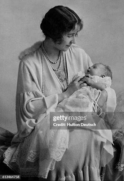 Elizabeth, Duchess of York holds her baby daughter Princess Elizabeth, the future Queen Elizabeth II of England.