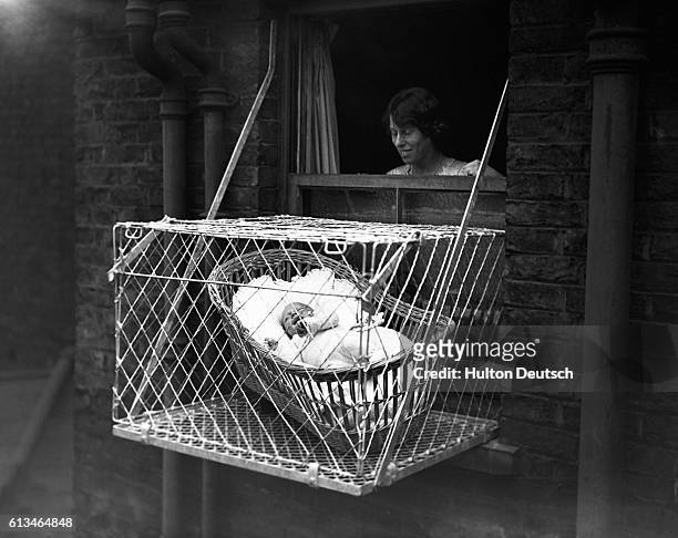 Baby in Cage Hung Out of Window