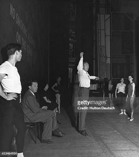 Russian dancer, choreographer and ballet master Georges Balanchine rehearses the New York City Ballet in London. Choreographer Frederick Ashton is...