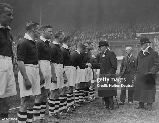 King George V of England shakes hands with the Manchester City soccer team before the kick-off of the Football Association Cup Final at Wembley.