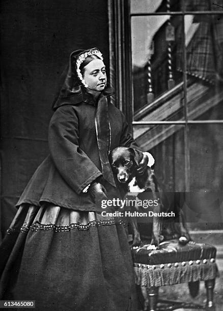 Queen Victoria At Balmoral, 1867. Queen Victoria with dog [Sharp?] with one of the very few photos in which the Queen is seen to smile.