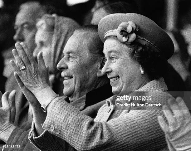 The Queen applauds and cheers on her husband Prince Phillip, as he competes in the coach trials at the 1985 Royal Windsor Horse Show.