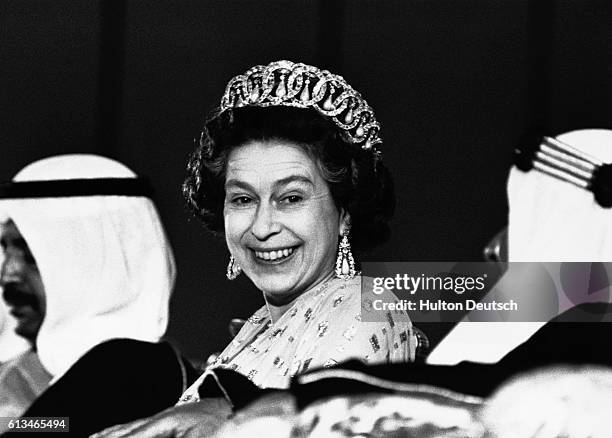 Queen Elizabeth II smiles during a 1979 visit to Bahrain, accompanied by the Emir.