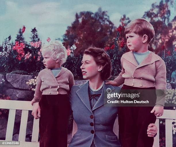 Queen Elizabeth II with her children Charles and Anne at Balmoral, 1952.