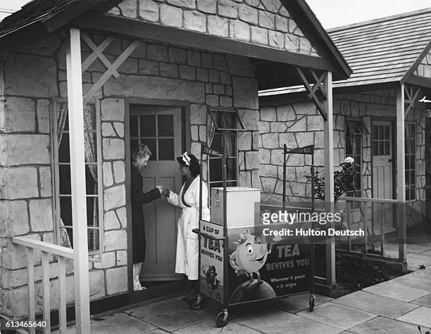 Morning tea is delivered to a chalet at a Butlin's Holiday Camp. It costs an extra bob for 7 early morning tea tickets.