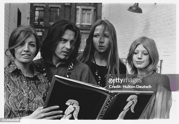 Sixties icons Christine Keeler, Penelope Tree, and Marianne Faithfull join photographer David Bailey around a copy of his book of sixties photographs...
