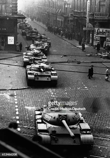 Russian tanks roll down a street in Budapest after the Soviet invasion of Hungary to suppress the anti-communist revolution in 1956.
