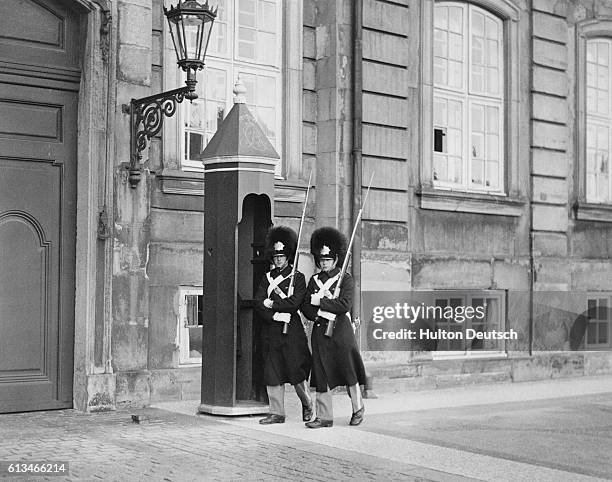 Guards march outside Amalienborg in Copenhagen at the time of the German invasion of Denmark and Norway in 1940.