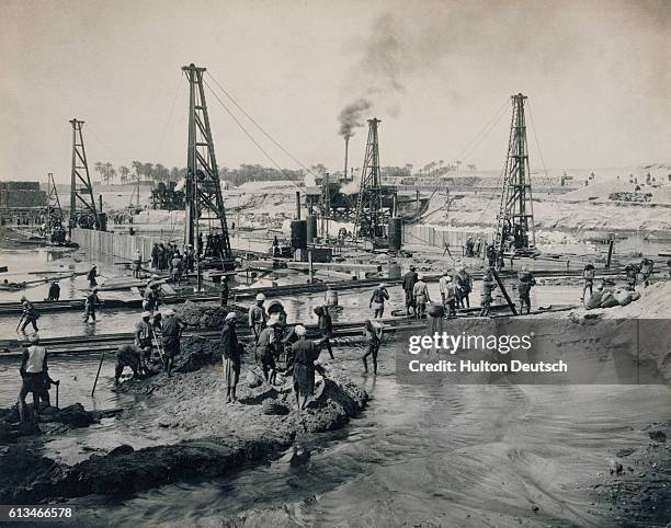 Cast iron pilings are laid during the construction of the Asyut Barrage across the River Nile.