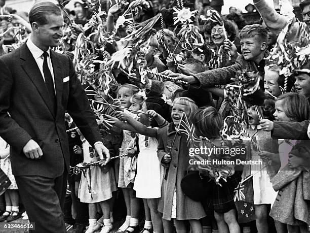 The Duke of Edinburgh is greeted by cheering children at Waipukurau, during the Royal visit to New Zealand.