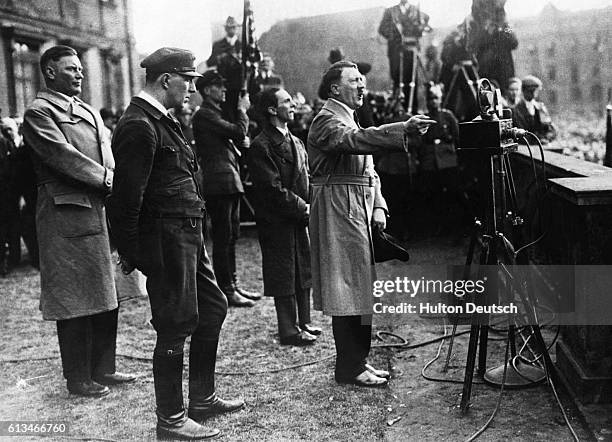 Nazi ideologue Joseph Goebbels stands beside Adolf Hitler as Hitler delivers a 1932 election speech. Hitler lost the 1932 presidential election to...