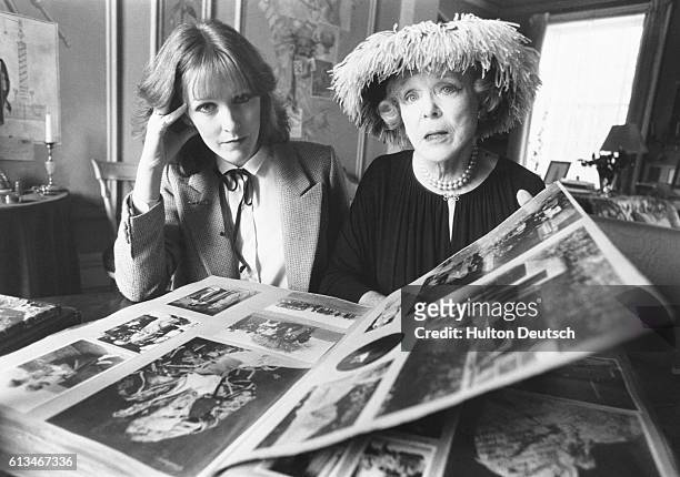 Actress Patricia Hodge and famous socialite Lady Diana Cooper look through photographs of the 1930's.