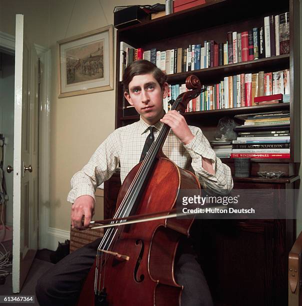 Prince Charles practices his cello playing in his rooms at Trinity College Cambridge, whilst an undergraduate there. | Location: Cambridge,...