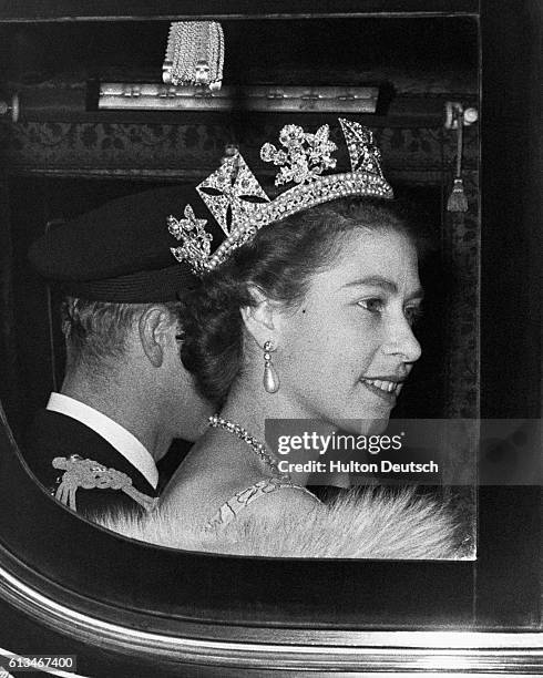 The Queen and the Duke of Edinburgh leave Buckingham Palace on their way to the Houses of Parliament for the Queen to perform the first State Opening...