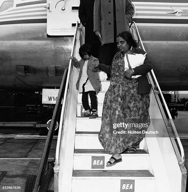 Asian immigrants expelled from Uganda disembark at London Airport. London. | Location: London Airport, England, UK.