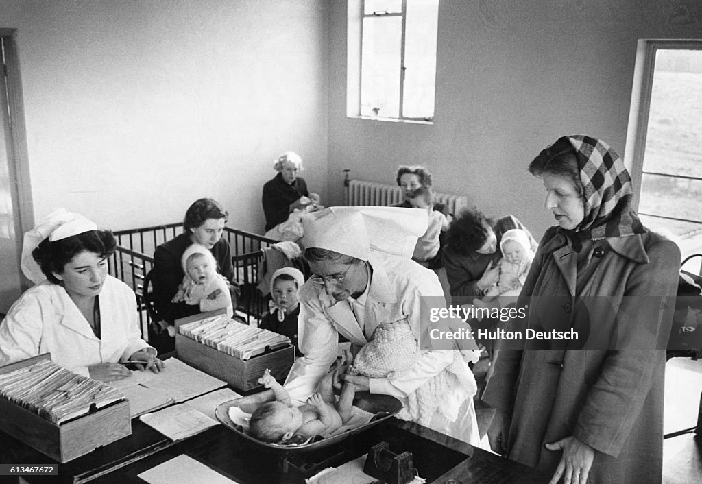 Nurse Weighs Infant at Children's Ward