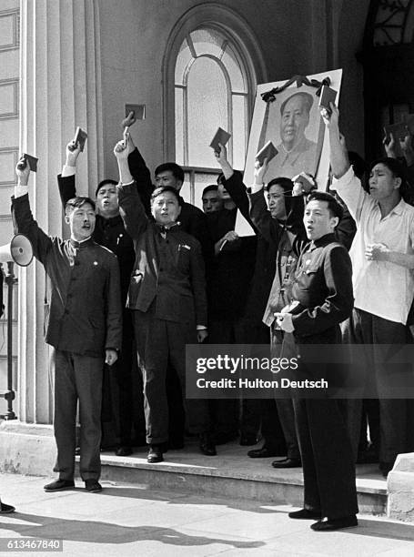 Original caption: Chinese Delegation Holding Up 'Little Red Books' And Banner Of Mao Tse Tung