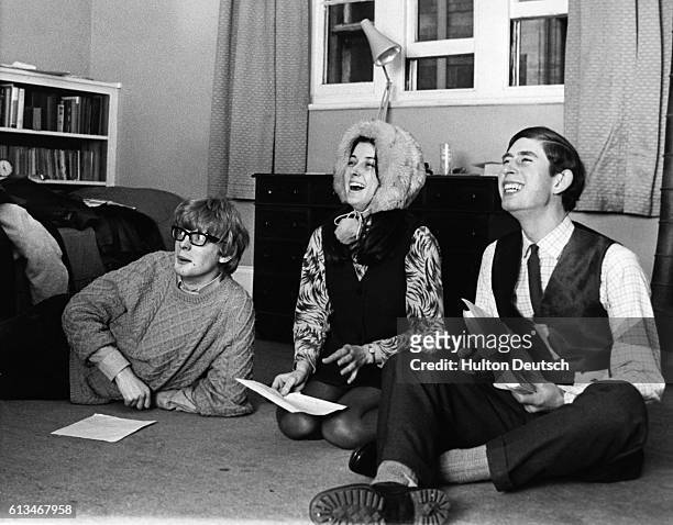 Prince Charles enjoys a joke with two of his fellow students at Cambridge University, whilst they rehearse for a revue. | Location: Cambridge,...