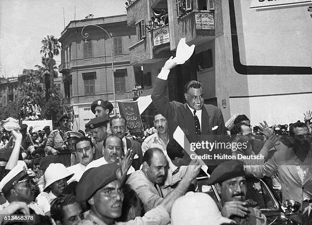 The Egyptian Prime Minister Gamal Nasser is cheered by a huge crowd on his arrival back in Cairo from Alexandria, where he announced he had taken...