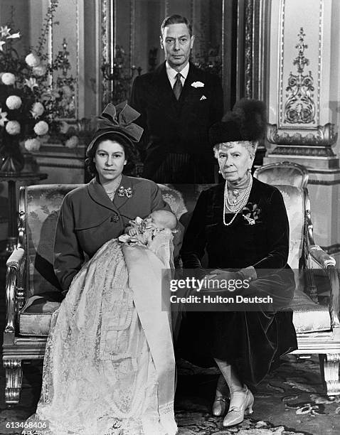 Four generations of the Royal Family pose for a photograph after the christening of Princess Elizabeth's baby son, Prince Charles. The baby's...