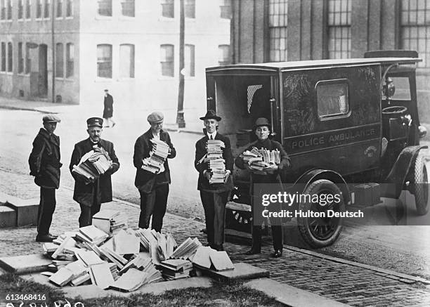Boston Police with piles of communist literature which they have raided and banned as a precaution against their fear of revolution in America.
