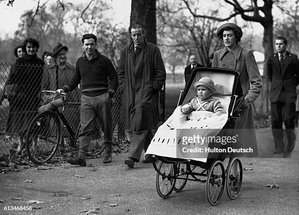 Prince Charles is pushed around Green Park in his pram by his nanny on his second birthday.