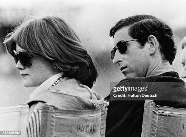 Prince Charles and Lady Sarah Spencer, the elder sister of Diana, whom he later married, watch a polo match at Windsor.